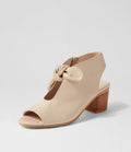 Beige open-toe shoe with wooden heel on a light gray background