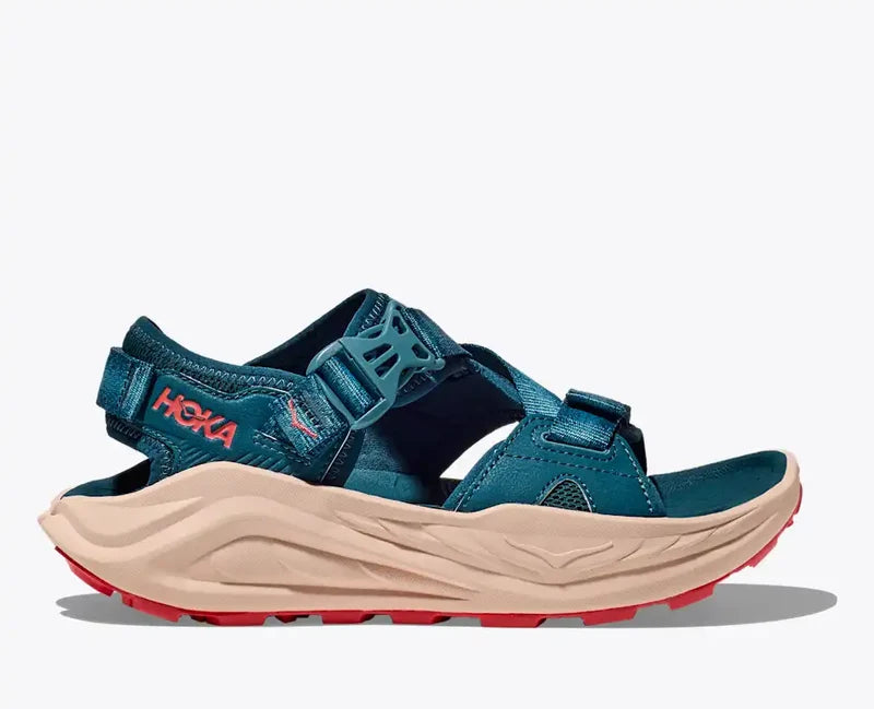Blue sandal with beige sole and red accents on a white background
